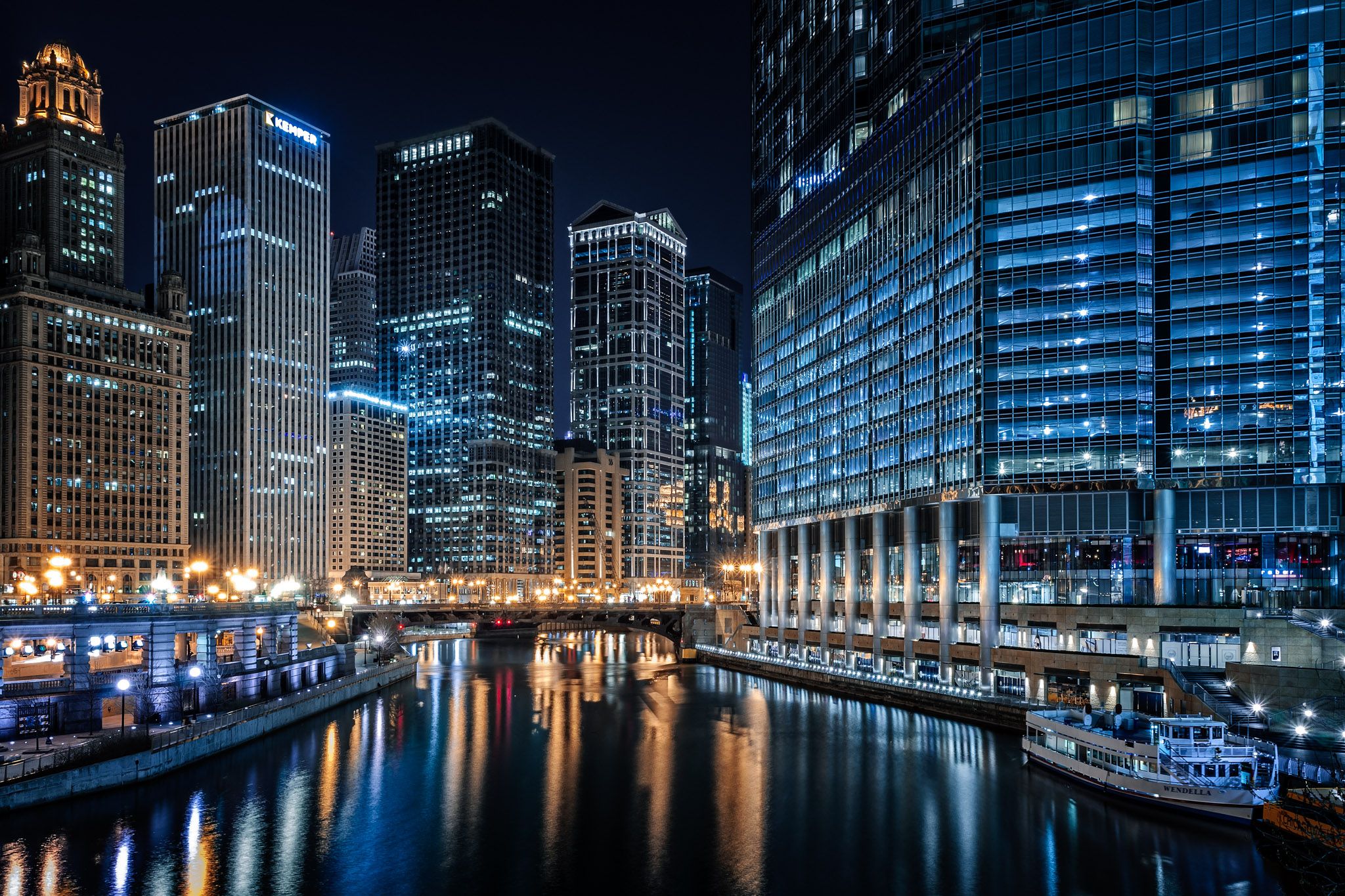 The Chicago River at night, lined with downtown towers in River North
